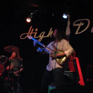 a man playing a guitar on stage