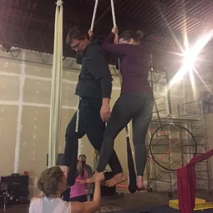 Instructor Anne adjusting my foot on static trapeze.