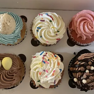 a variety of frosted cupcakes