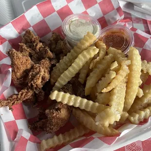 Chicken fingers and crinkle fries with ranch and hot sauce