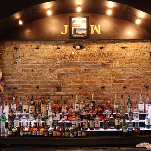 a brick wall with a sign above it