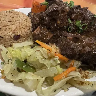 Oxtail, rice and peas, cabbage. Wish it would have come with plantain. It did not.