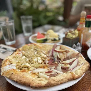 1/2 lemon artichoke pizza; 1/2 bacon and pear pizza