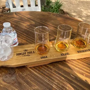 four glasses and a bottle of water