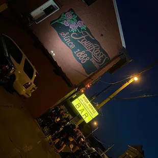 a neon sign on the side of a building