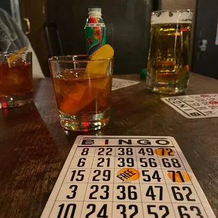 a table with a bingo card and a drink