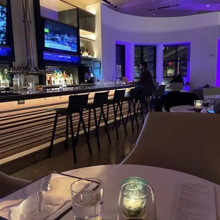 a bar with tables and chairs