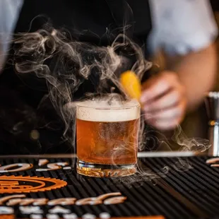 The Smoking Gun with bacon washed Jeffersons Bourbon, maple simple, angostura bitters, orange