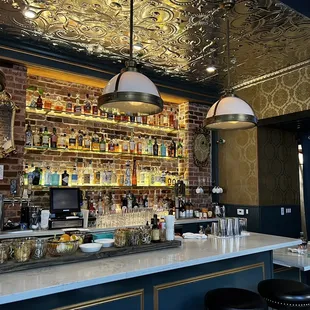 a bar with a lot of bottles on the shelves