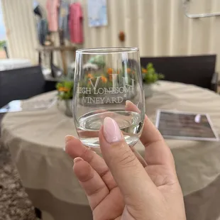 a hand holding a wine glass