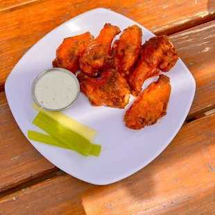 a plate of chicken wings and a pickle