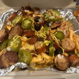 a hot dog with cheese and jalapenos