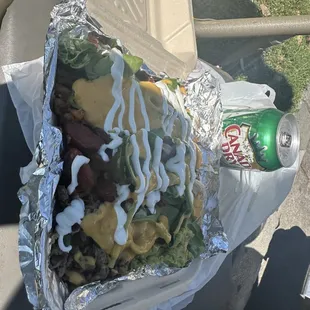 a sandwich wrapped in aluminum foil