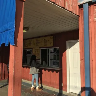 a woman standing outside of a restaurant