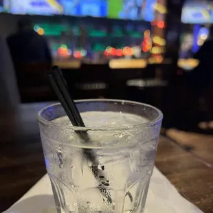 a glass of water with a straw in it