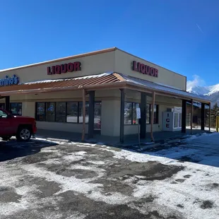 a red truck parked in front of a building