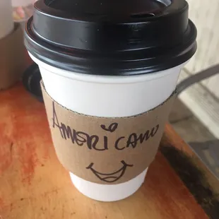 a cup of coffee with the words americano written on it