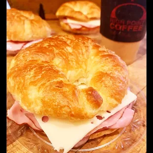 a croissant sandwich with ham and cheese
