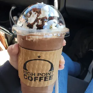 a person holding a cup of coffee