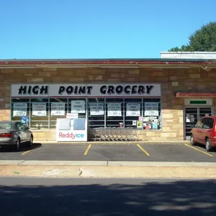 two cars parked in front of the store
