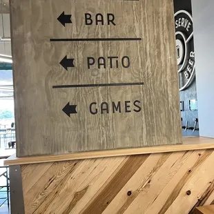 a wooden bar with directional signs