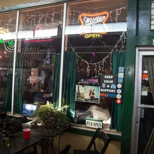 a woman sitting at a table outside