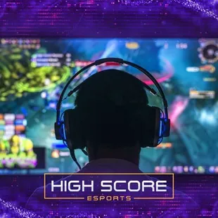 a man wearing headphones and watching a video game