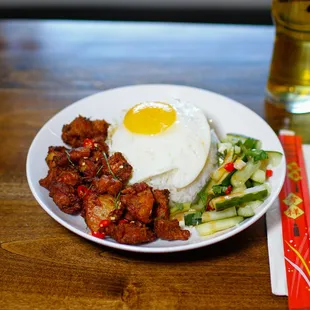 Lemongrass Fried Chicken Over Rice with egg and mala pickled cucumbers