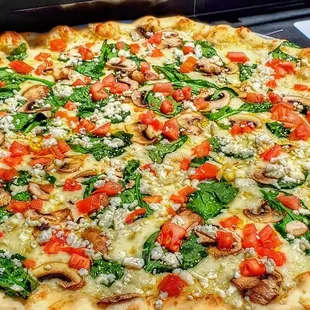 White Pizza. Spinach, mushroom, fresh tomato, feta, basil &amp; garlic infused olive oil
