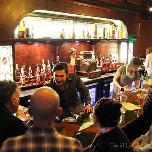 a group of people sitting at a bar