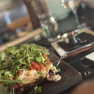 a slice of pizza on a cutting board
