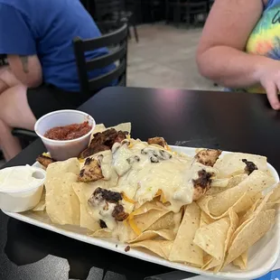 a plate of nachos and salsa