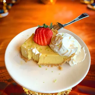 Key Lime Pie with whipped cream and a fresh strawberry.  Sweet.