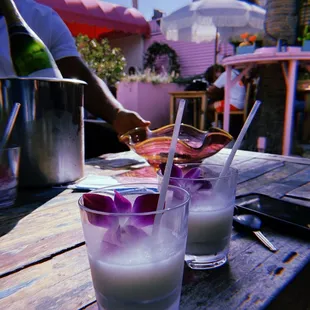 two glasses of drink on a wooden table