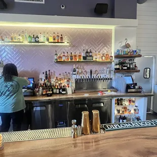 a woman standing at a bar