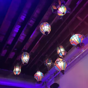 a bunch of colorful lights hanging from the ceiling