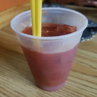 a plastic cup with a straw sticking out of it