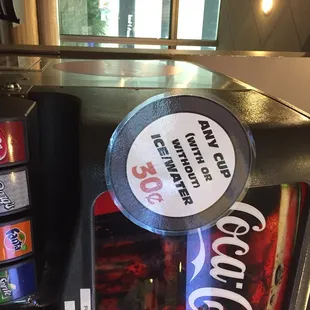 a vending machine with a coke machine in the background