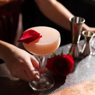 a close up of a person&apos;s hand holding a cocktail glass