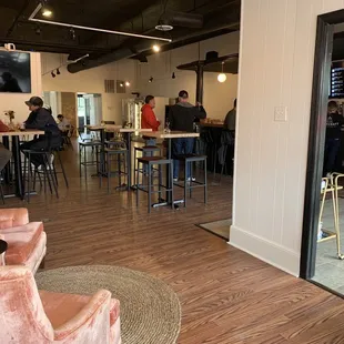 people sitting at tables in a coffee shop