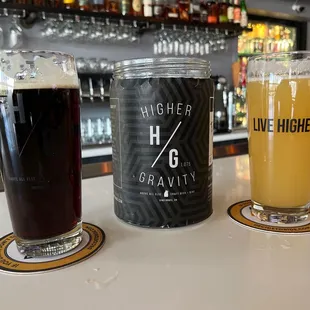 two glasses of beer and a can of beer