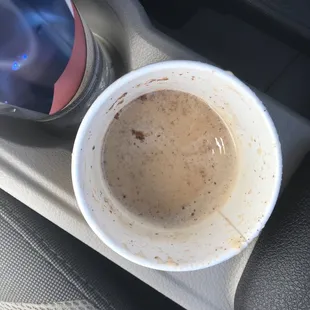 a cup of coffee in a cup holder