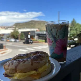 Asiago bagel with bacon, eggs and cheddar. Carmel iced latte.