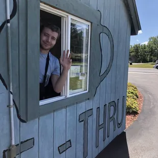 a man waving out of a window