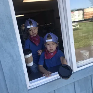 two children looking out the window