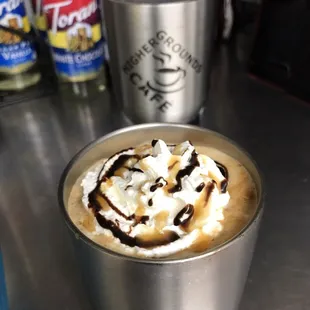 a cup of coffee with whipped cream and chocolate
