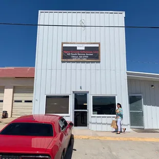 a red car parked in front of the building
