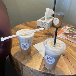 two cups of coffee on a wooden table