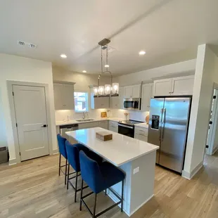 Beautiful kitchens feature quartz or honed granite countertops, and full size appliances.