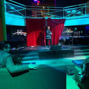 a man standing on a stage in front of a crowd